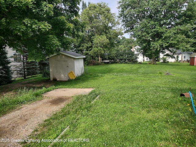 518 Clark St, Eaton Rapids, MI 48827 - view of green lawn with a storage shed