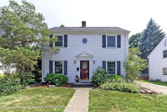 720 Linden St, East Lansing, MI 48823 - colonial house with a front yard and a chimney
