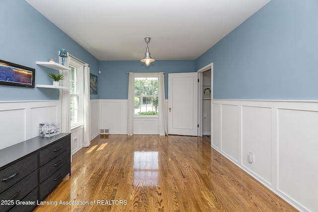 720 Linden St, East Lansing, MI 48823 - entrance foyer with a wainscoted wall, a decorative wall, and wood finished floors