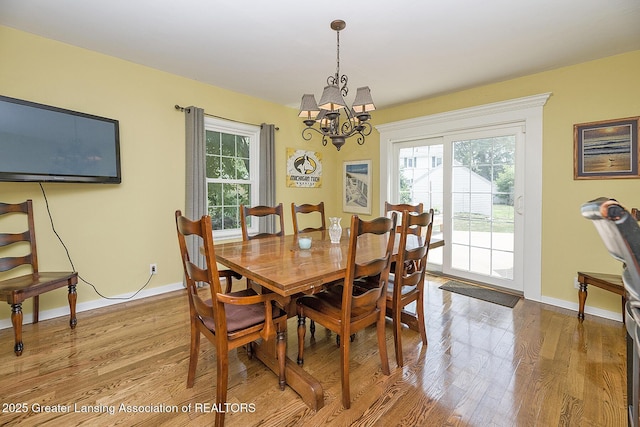 720 Linden St, East Lansing, MI 48823 - dining area with healthy amount of natural light, a chandelier, and wood finished floors