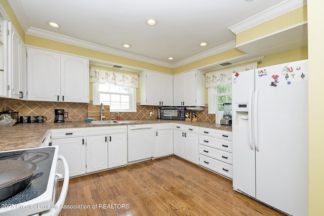 720 Linden St, East Lansing, MI 48823 - kitchen featuring white appliances, crown molding, healthy amount of natural light, white cabinetry, and recessed lighting
