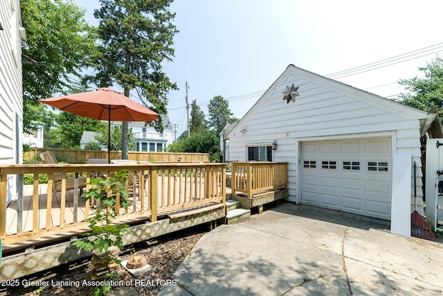 720 Linden St, East Lansing, MI 48823 - view of side of home with driveway, a wooden deck, and a garage