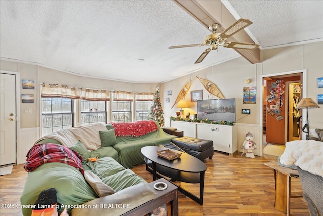 9428 S Wright Rd, Eagle, MI 48822 - living area with a textured ceiling, wood finished floors, ceiling fan, ornamental molding, and a wainscoted wall