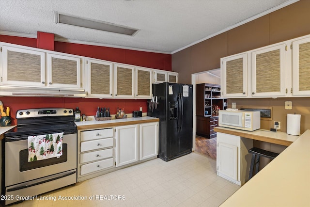9428 S Wright Rd, Eagle, MI 48822 - kitchen featuring stainless steel range with electric stovetop, black refrigerator with ice dispenser, under cabinet range hood, white microwave, and light countertops