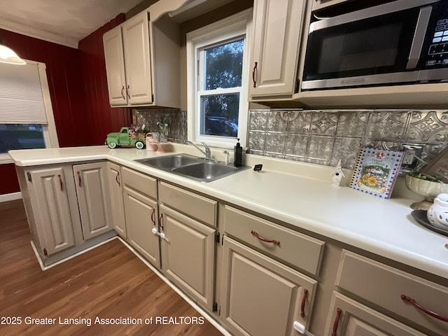 315 Oyer St, Springport, MI 49284 - kitchen featuring stainless steel microwave, dark wood finished floors, tasteful backsplash, light countertops, and a peninsula