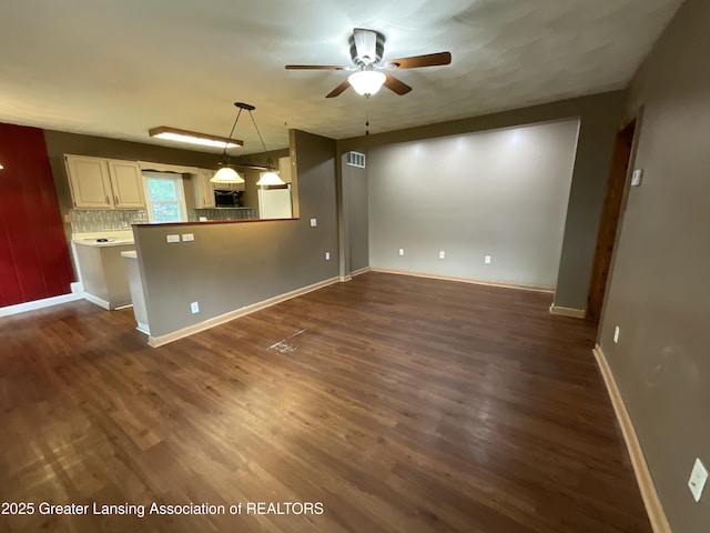 315 Oyer St, Springport, MI 49284 - unfurnished living room with a ceiling fan and dark wood-style floors