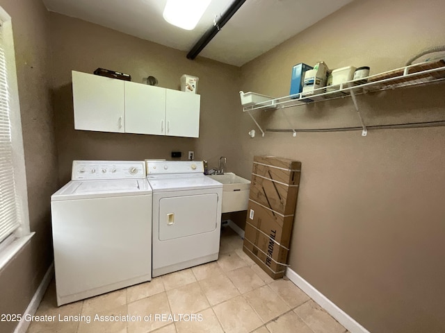 315 Oyer St, Springport, MI 49284 - laundry room featuring cabinet space, washing machine and dryer, and light tile patterned flooring