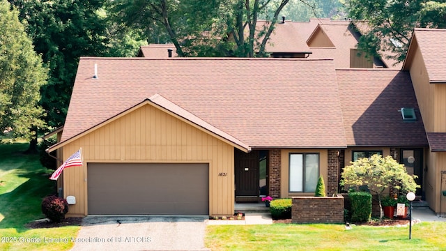 1621 Willow Creek Dr, Lansing, MI 48917 - view of front of property featuring a garage, a shingled roof, a front yard, and driveway