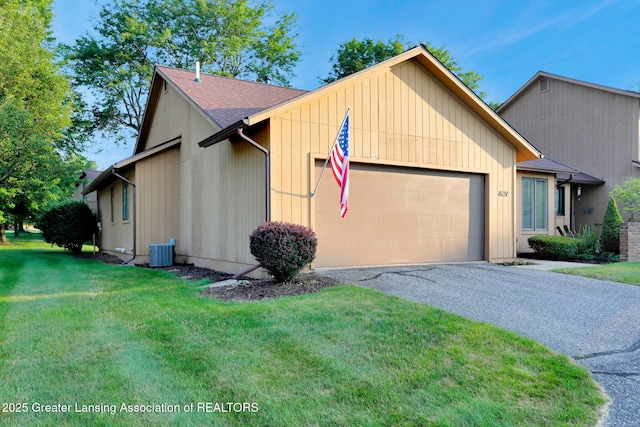 1621 Willow Creek Dr, Lansing, MI 48917 - view of front facade featuring a garage, a front lawn, driveway, and a shingled roof