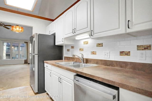 1621 Willow Creek Dr, Lansing, MI 48917 - kitchen featuring stainless steel appliances, white cabinets, backsplash, light colored carpet, and a chandelier