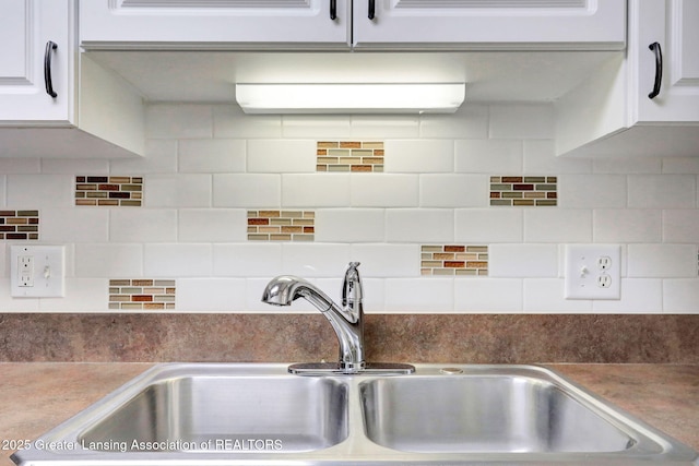 1621 Willow Creek Dr, Lansing, MI 48917 - kitchen with white cabinetry and tasteful backsplash
