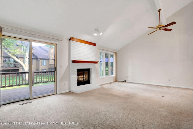1621 Willow Creek Dr, Lansing, MI 48917 - unfurnished living room featuring a brick fireplace, carpet floors, plenty of natural light, ceiling fan, and lofted ceiling