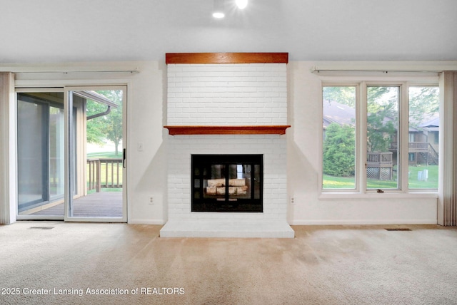 1621 Willow Creek Dr, Lansing, MI 48917 - unfurnished living room with carpet, plenty of natural light, and a fireplace