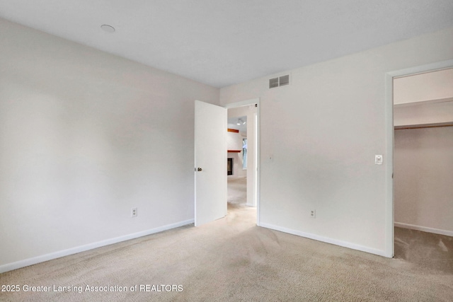 1621 Willow Creek Dr, Lansing, MI 48917 - unfurnished bedroom with a spacious closet and carpet