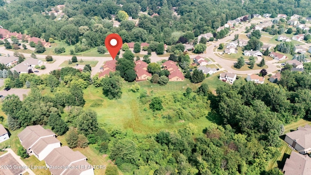 1621 Willow Creek Dr, Lansing, MI 48917 - aerial overview of property's location featuring nearby suburban area and a heavily wooded area