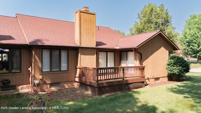 1621 Willow Creek Dr, Lansing, MI 48917 - rear view of property with roof with shingles, a chimney, a lawn, and a wooden deck