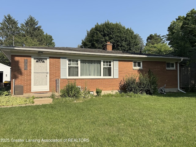 5626 Hallendale Rd, Haslett, MI 48840 - ranch-style house featuring brick siding, a front yard, and a chimney