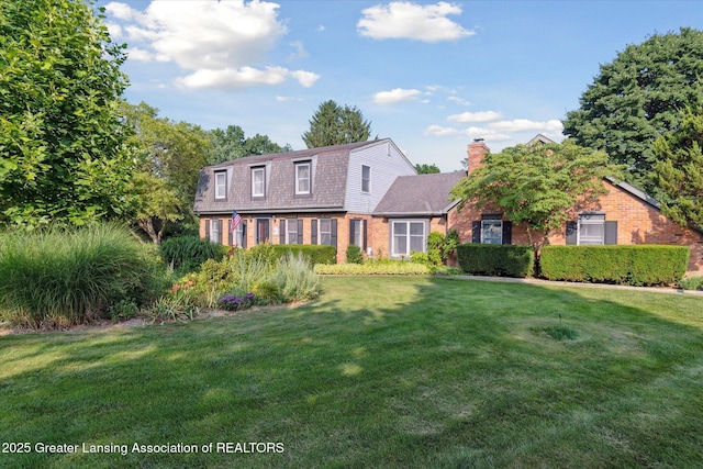9303 Blueberry Ct, Howell, MI 48843 - dutch colonial with brick siding, a front lawn, and a gambrel roof