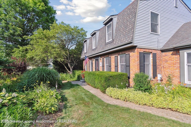 9303 Blueberry Ct, Howell, MI 48843 - view of side of property with brick siding and a shingled roof