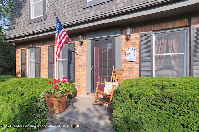 9303 Blueberry Ct, Howell, MI 48843 - doorway to property with brick siding and a shingled roof