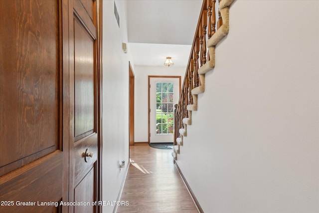9303 Blueberry Ct, Howell, MI 48843 - corridor featuring stairway and dark wood finished floors