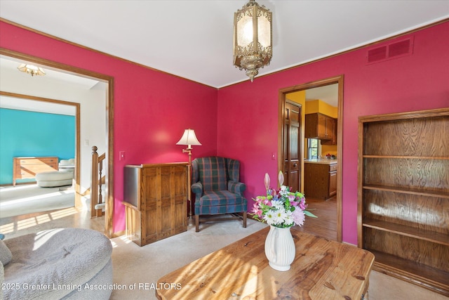 9303 Blueberry Ct, Howell, MI 48843 - living area featuring a chandelier and carpet