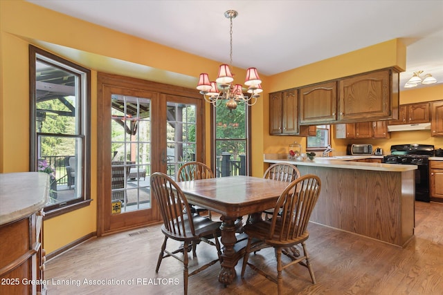 9303 Blueberry Ct, Howell, MI 48843 - dining room with a chandelier and light wood-type flooring