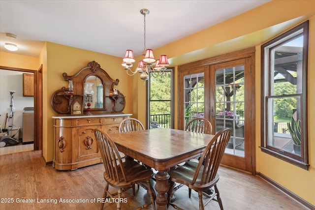 9303 Blueberry Ct, Howell, MI 48843 - dining area with a chandelier and light wood finished floors