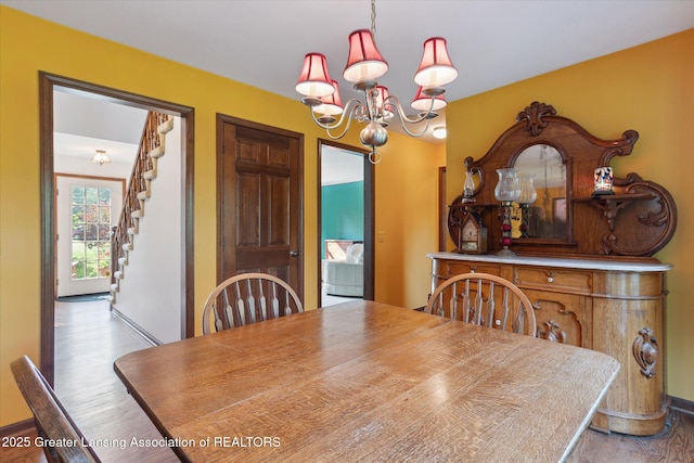 9303 Blueberry Ct, Howell, MI 48843 - dining room featuring a chandelier, wood finished floors, and stairs