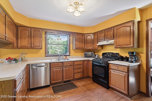 9303 Blueberry Ct, Howell, MI 48843 - kitchen featuring black gas range, stainless steel dishwasher, brown cabinets, and light countertops