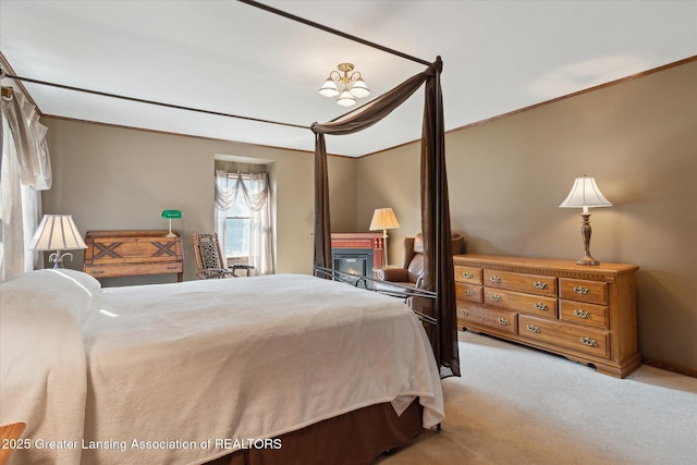 9303 Blueberry Ct, Howell, MI 48843 - carpeted bedroom featuring a glass covered fireplace