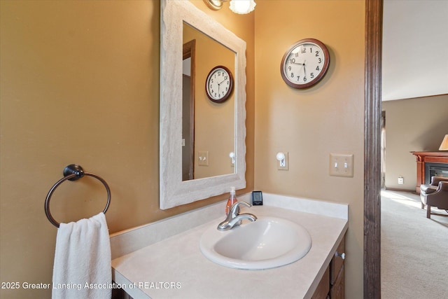 9303 Blueberry Ct, Howell, MI 48843 - bathroom featuring vanity and a glass covered fireplace