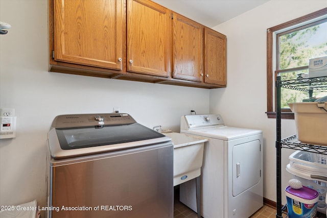 9303 Blueberry Ct, Howell, MI 48843 - laundry area featuring cabinet space and independent washer and dryer