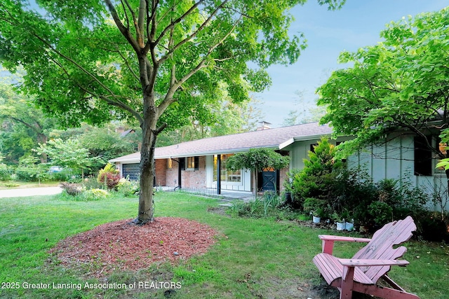 2315 Hamilton Rd, Okemos, MI 48864 - ranch-style house featuring covered porch, a front lawn, a chimney, brick siding, and a shingled roof