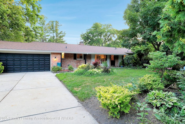 2315 Hamilton Rd, Okemos, MI 48864 - ranch-style home featuring a garage, driveway, brick siding, a chimney, and a front yard