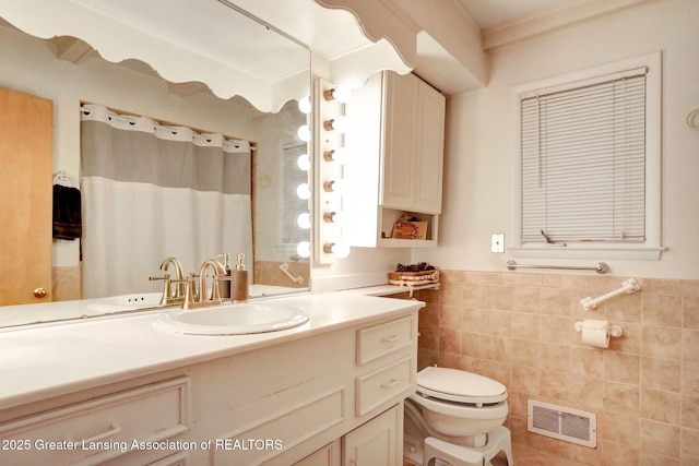 2315 Hamilton Rd, Okemos, MI 48864 - full bathroom featuring vanity, tile walls, a wainscoted wall, and a shower with curtain