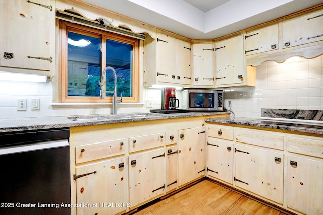 2315 Hamilton Rd, Okemos, MI 48864 - kitchen with dishwashing machine, backsplash, light wood-style flooring, and stainless steel microwave
