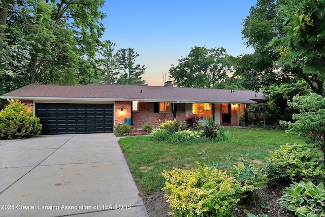2315 Hamilton Rd, Okemos, MI 48864 - single story home featuring driveway, an attached garage, a chimney, brick siding, and a yard