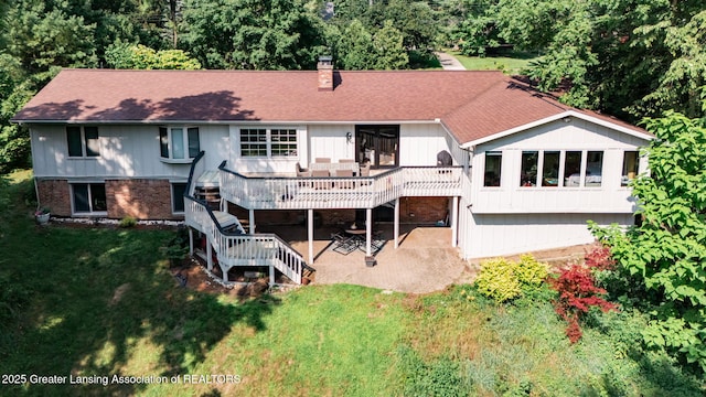 2315 Hamilton Rd, Okemos, MI 48864 - back of house with a patio area, a wooden deck, a yard, a chimney, and stairs