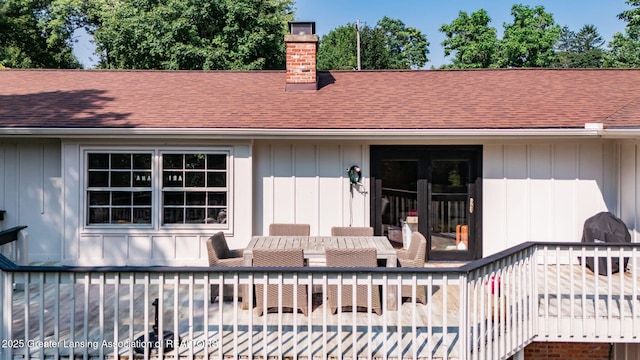 2315 Hamilton Rd, Okemos, MI 48864 - rear view of house featuring a shingled roof, a chimney, and board and batten siding