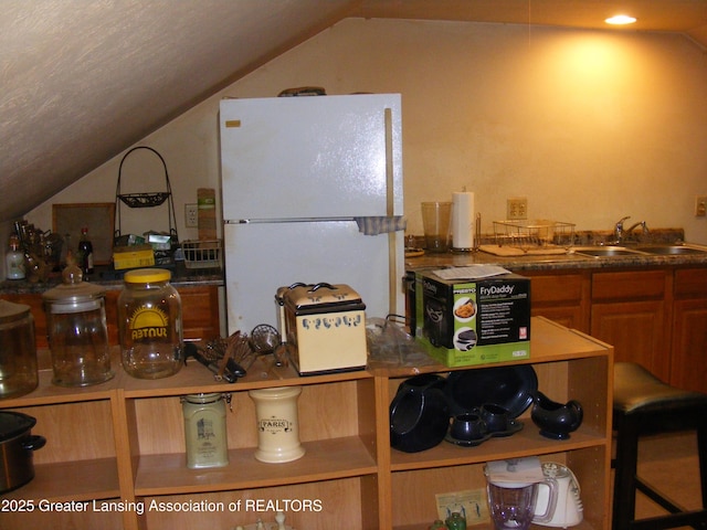 1002 Water St, Eaton Rapids, MI 48827 - kitchen with vaulted ceiling and freestanding refrigerator