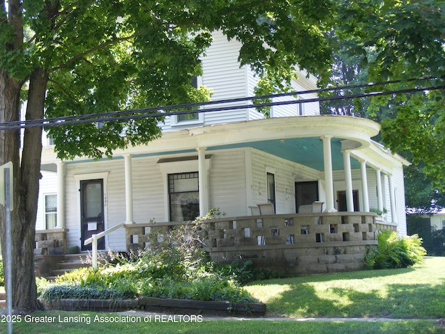 1002 Water St, Eaton Rapids, MI 48827 - view of front of home with covered porch and a front lawn
