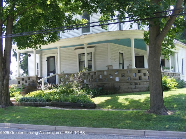 1002 Water St, Eaton Rapids, MI 48827 - view of front facade featuring a porch and a front lawn