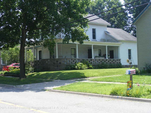 1002 Water St, Eaton Rapids, MI 48827 - view of front of house with roof with shingles, covered porch, and a front yard