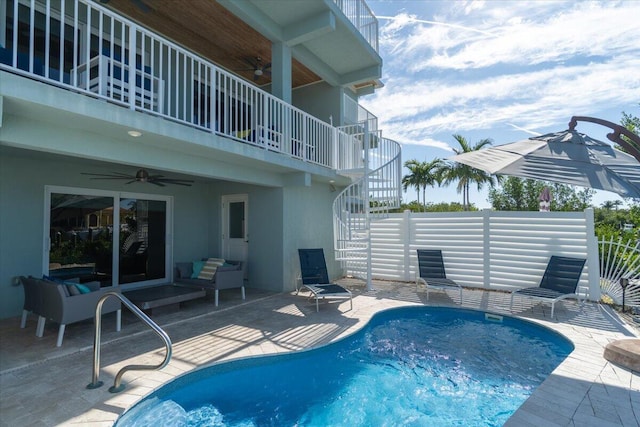 outdoor pool featuring a patio, ceiling fan, and stairway