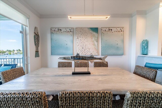 dining space with plenty of natural light and crown molding