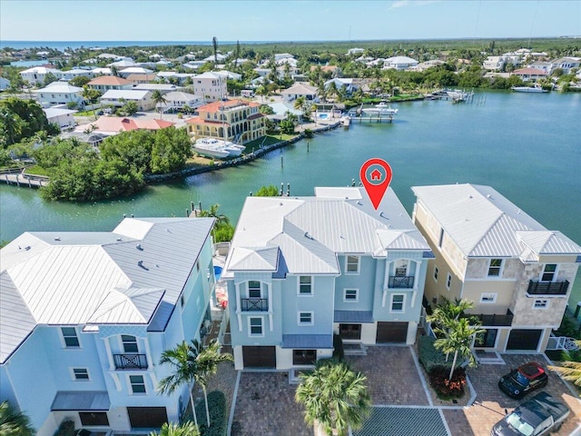 drone / aerial view with a residential view and a water view