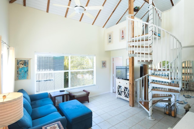 tiled living area featuring high vaulted ceiling, beam ceiling, wood ceiling, stairway, and ceiling fan