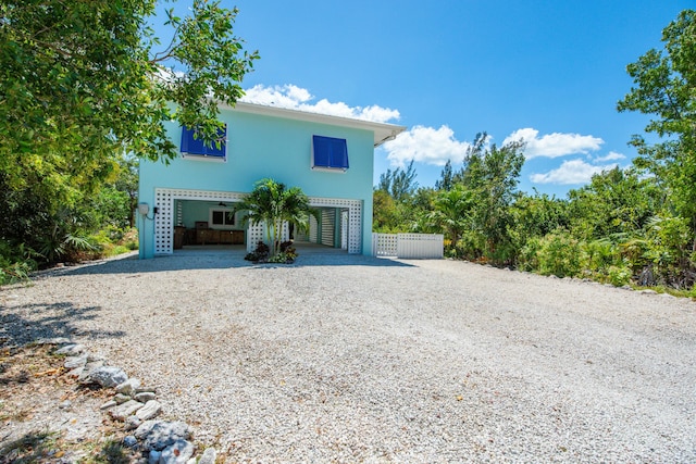view of front of house with driveway and a carport