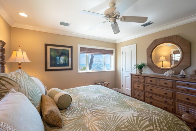 bedroom featuring baseboards, visible vents, and ornamental molding